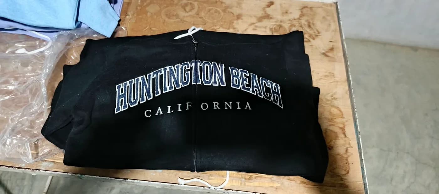 Black Huntington Beach zip hoodie, folded